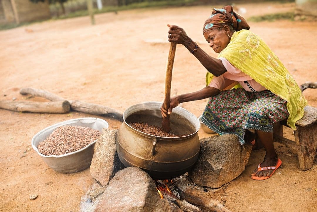 a person cooking food in a wok
