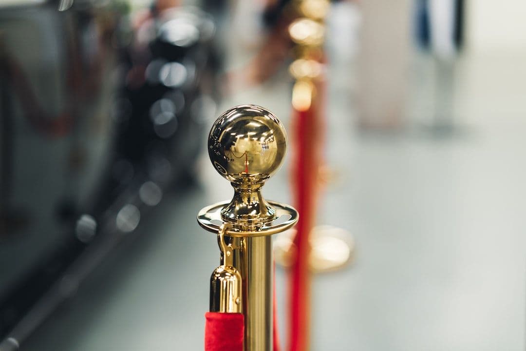 a row of red and gold poles with a golden ball on top